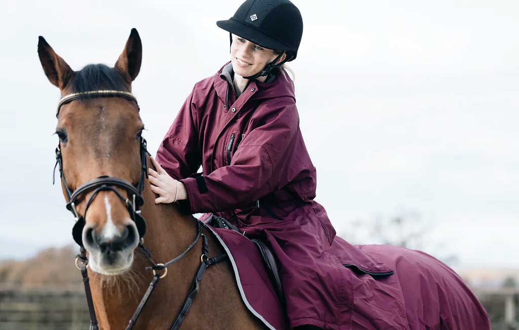 Maroon equidry evolution waterproof riding coat with black trim front zipper hidden storm skirts and fleece lining