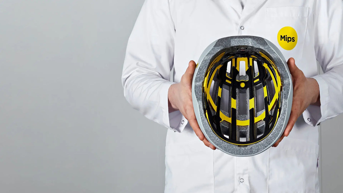 Silver and yellow mips riding helmet with sleek design and black padding for mips rider safet and mips helmets