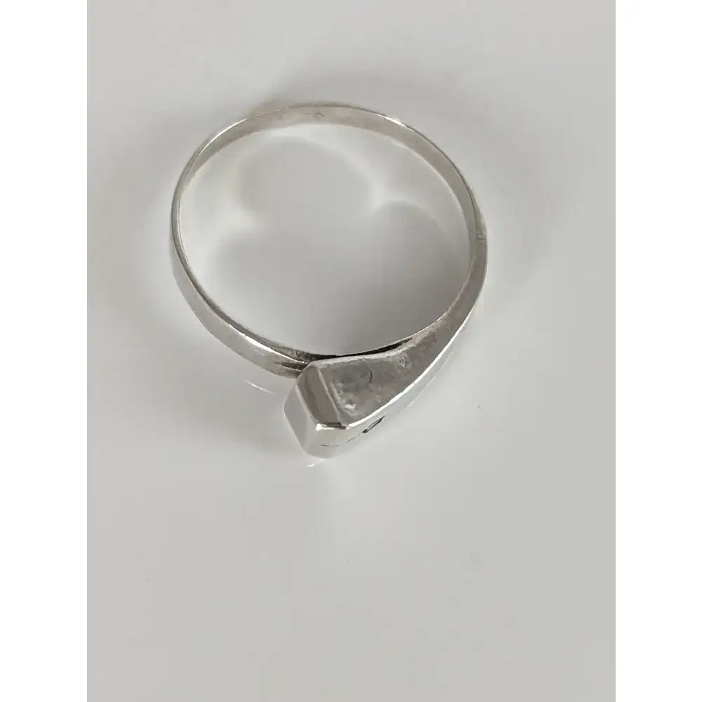 A sleek silver hoof nail ring handmade with a geometric faceted hexagonal stone for an equestrian gift