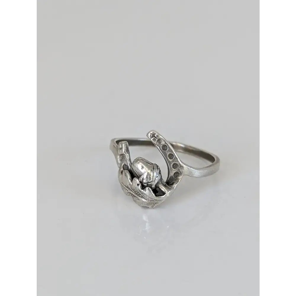 Silver horseshoe and oak leaf ring featuring a detailed hand design made of 925 silver symbolic nature gift