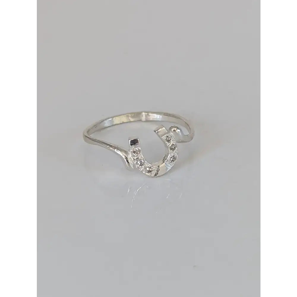 Delicate silver horseshoe ring with small sparkling cubic zirconia stones perfect as a lucky equestrian gift