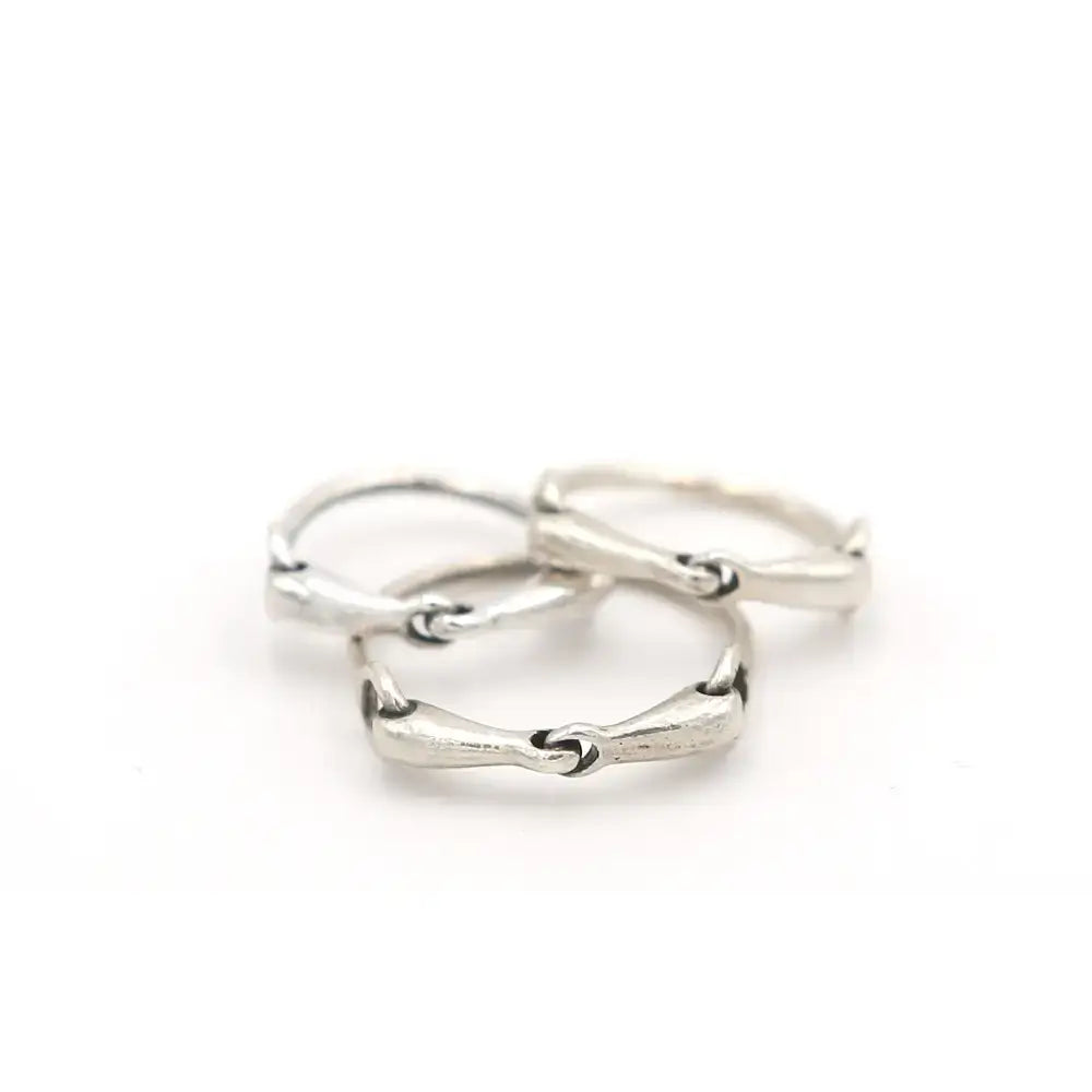Three silver snaffle bit rings with handmade equestrian flat band design and textured segmented bands in 925 silver