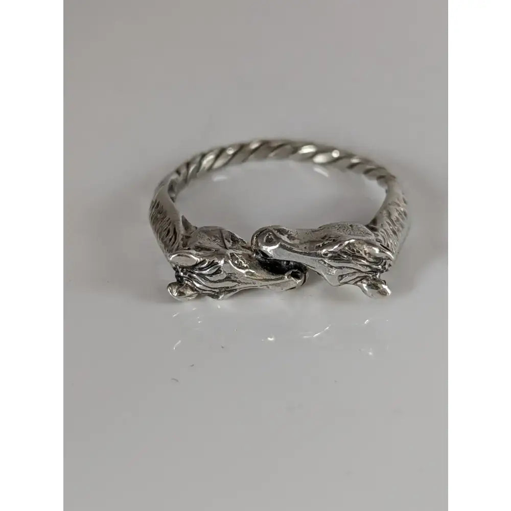 Silver two horse heads ring featuring twisted band and detailed interlocking heads perfect for equestrian gifts