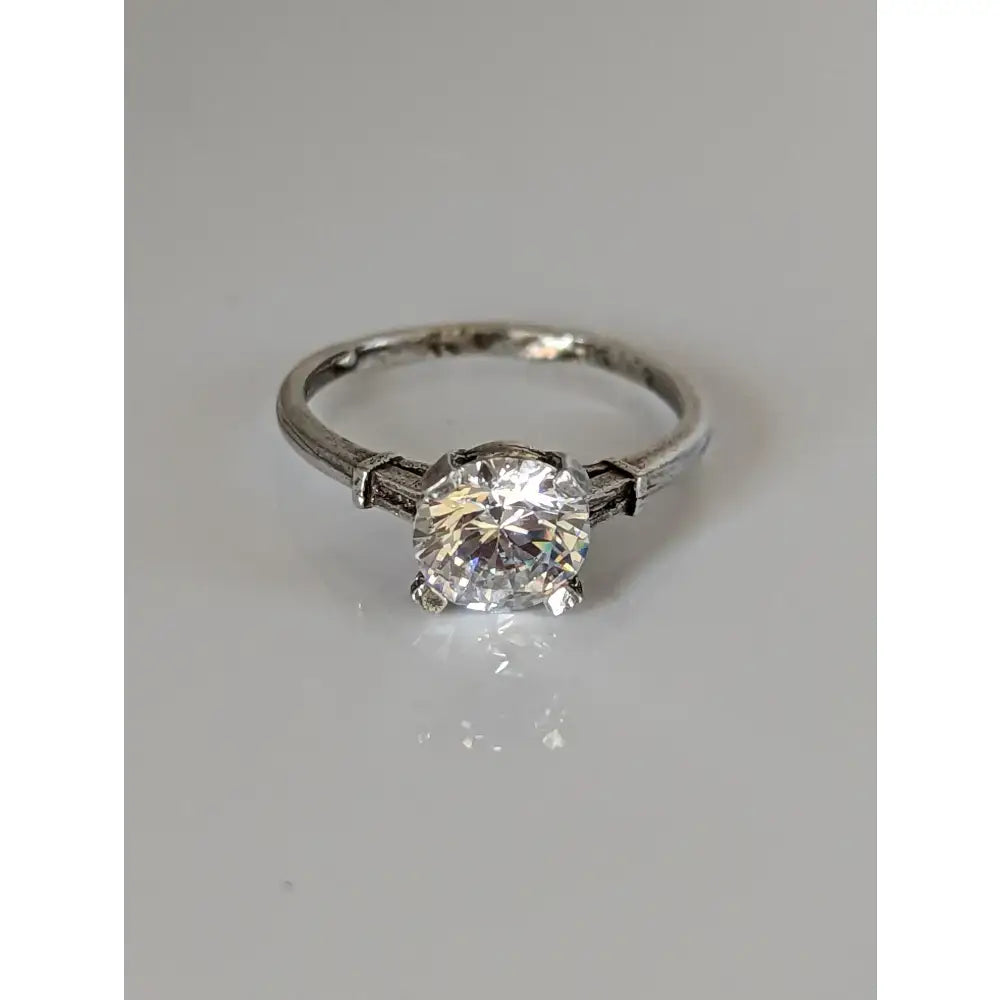 Vintage-style platinum engagement ring with round brilliant-cut diamond and ornate band handmade elegant sparkle