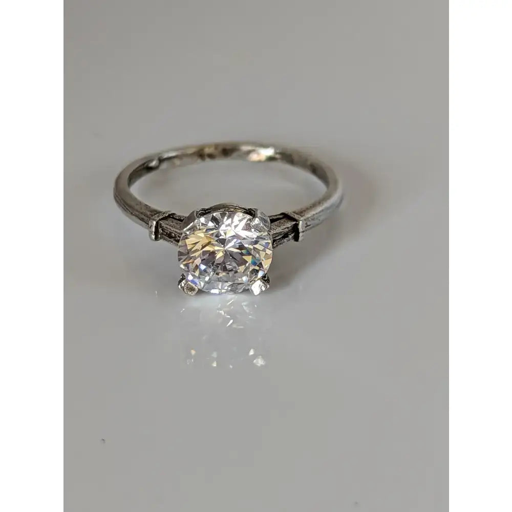 A handmade elegant sparkle silver zirconia ring with a vintage platinum band and a brilliant-cut zirconia stone