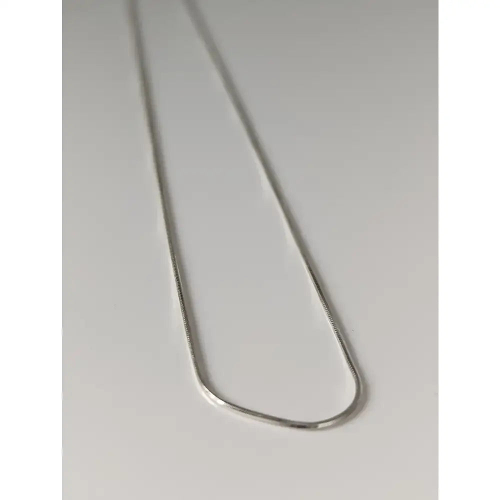 A sleek silver-toned sterling silver chain necklace with smooth reflective finish from small artisan batches timeless jewellery