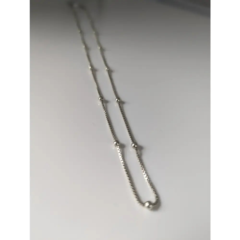 Silver chain necklace with delicate box-link design and small beads from a 925 sterling silver chain collection