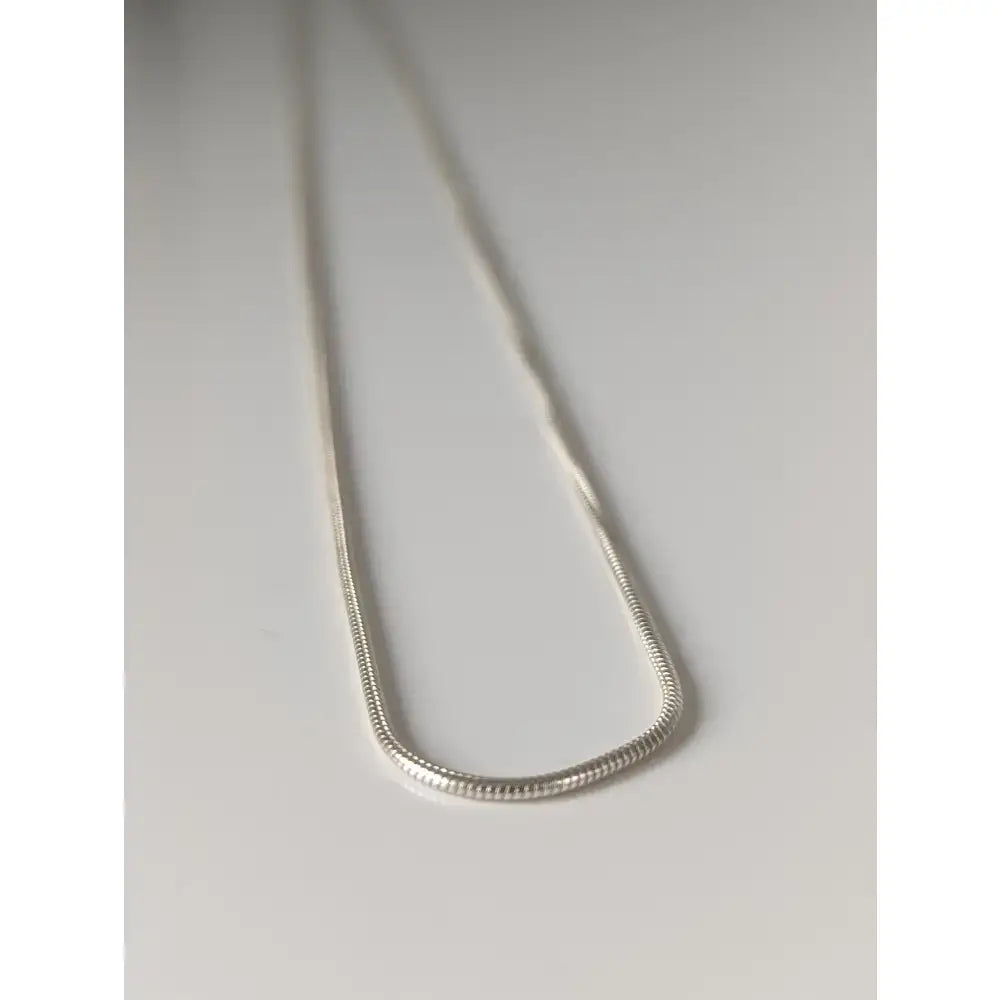 A sleek silver sterling silver chain necklace with polished reflective finish from small artisan batches timeless jewellery