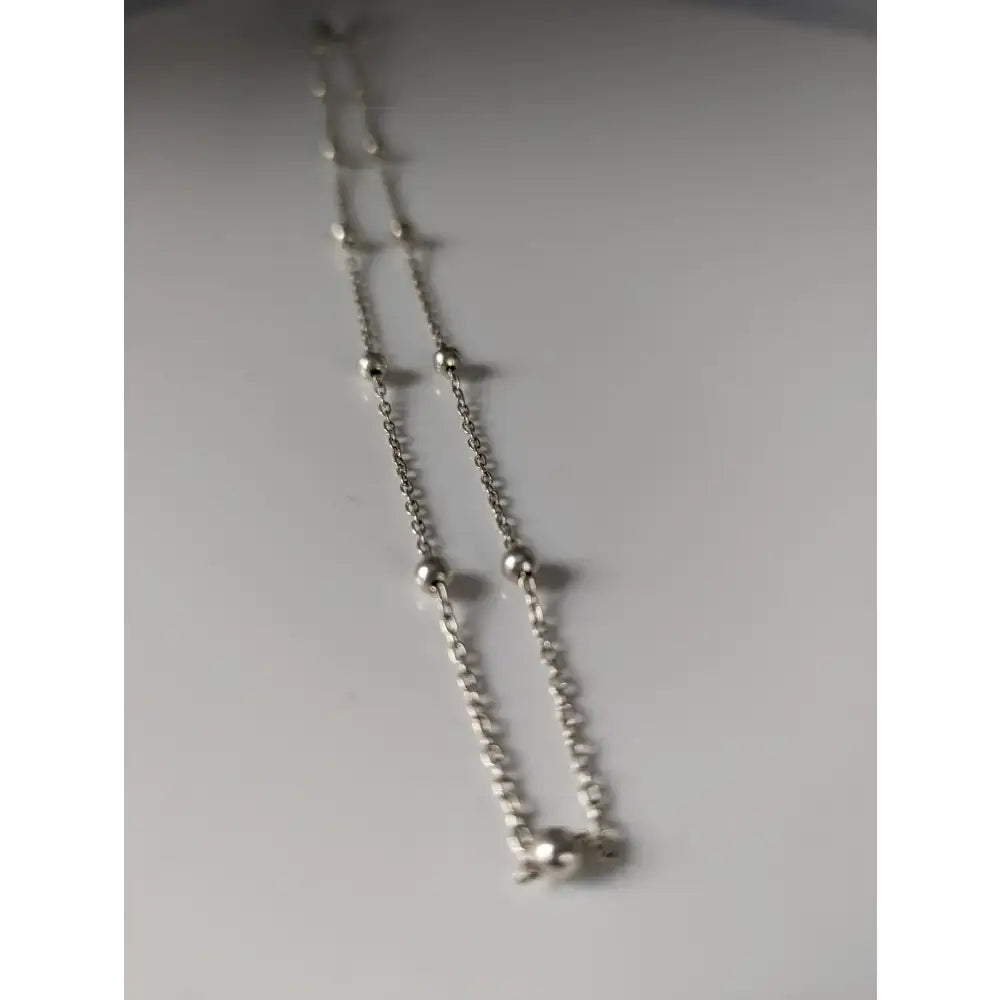 Silver sterling silver chain necklace with small spherical beads and delicate elephant charm from small artisan batches timeless jewellery