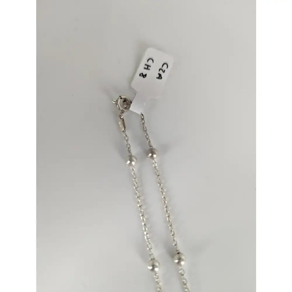 Silver ball chain necklace with clasp and tag made from sterling silver chain crafted in small artisan batches for timeless jewellery