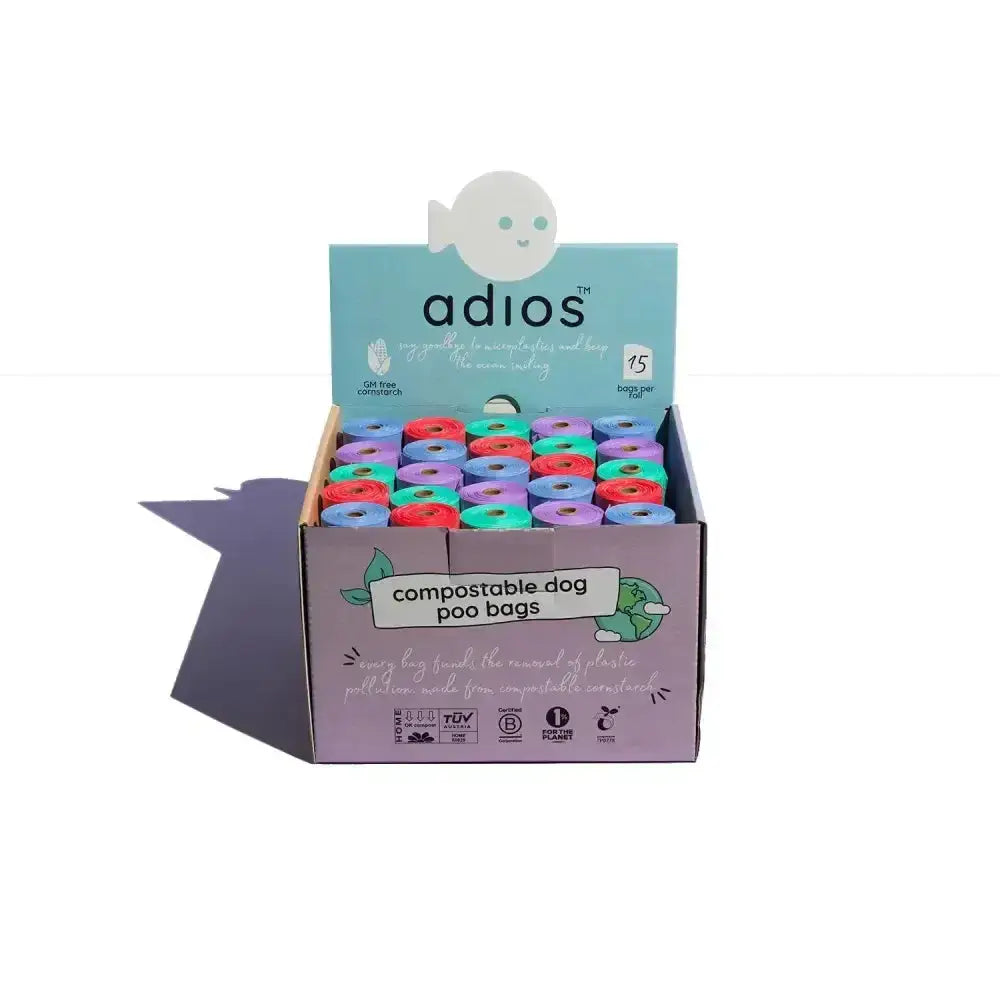 A box of colorful compostable adios pos poo bags in red blue green and purple in a poo bag counter unit