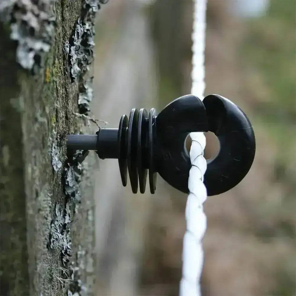 Black plastic rope guide with ring and spiral design on tree bark for agrifence maxicord braided rope smooth contact surface