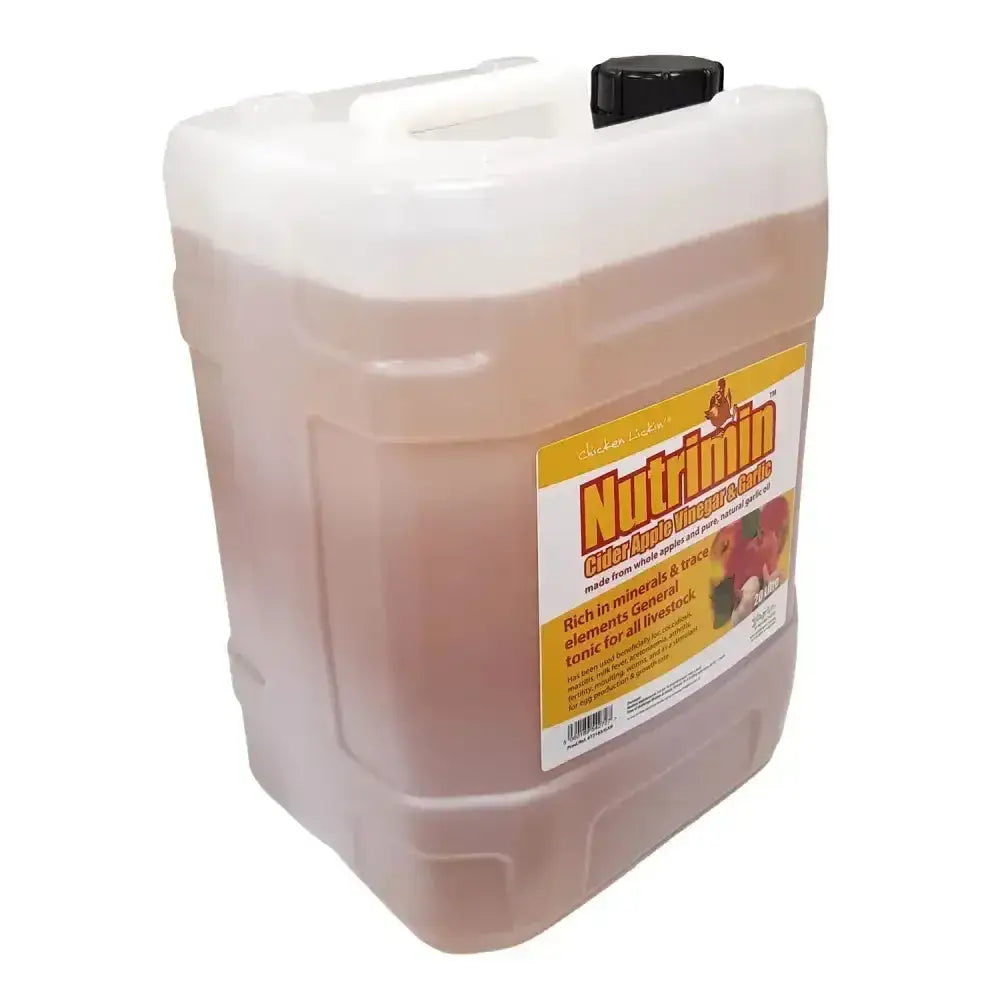 A translucent plastic jug of amber nutrimin cider vinegar with garlic from agrivite chicken lickin with a black cap