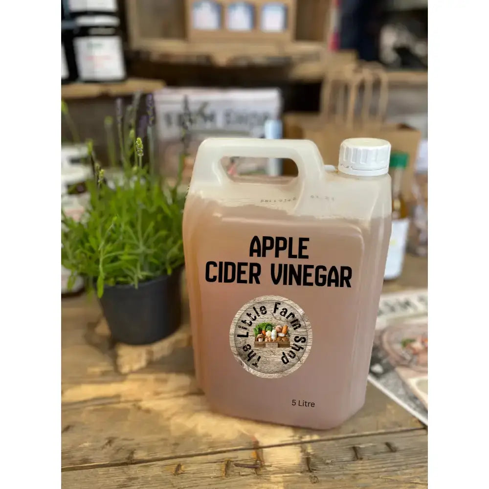 A 5-litre translucent plastic jug of amber apple cider vinegar with a white cap from the little farm shop for horse owners and poultry keepers digestive health
