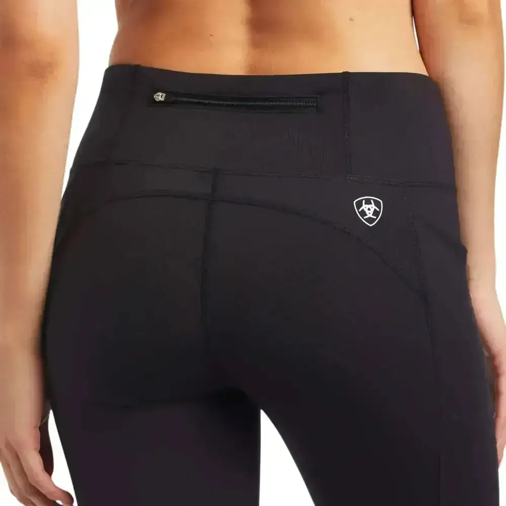 Back view of black ariat ladies eos knee patch riding tights with zippered phone pocket and white logo on hip