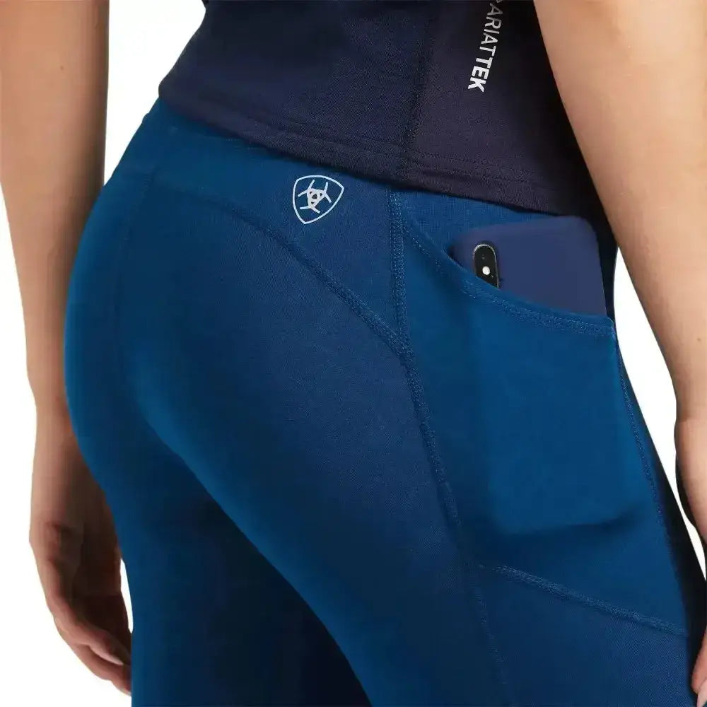 Deep blue ariat ladies eos knee patch riding tights with zippered phone pocket and subtle white logo on hip