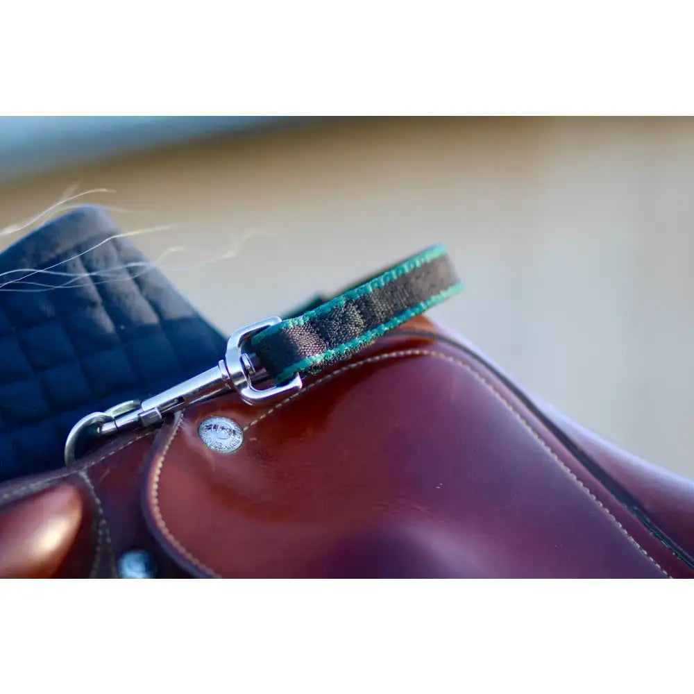 Teal and black plaid leather balance handle saddle pad strap with silver buckle featuring rubber grip and trigger clips