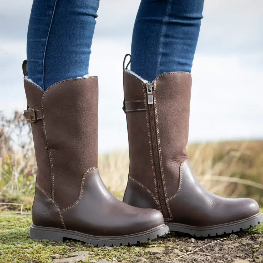 Brown leather knee-high bareback footwear quebec waterproof zip-up fur lined boots with side zipper and buckle detail