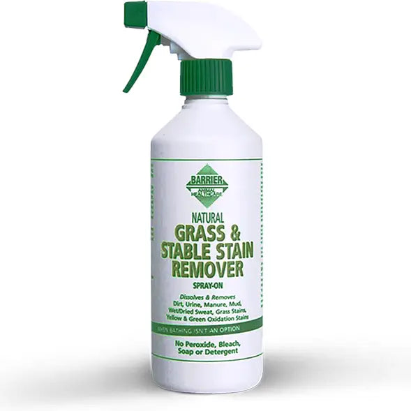 White plastic spray bottle with green cap labeled barrier grass and stable stain remover removes heavy soiling
