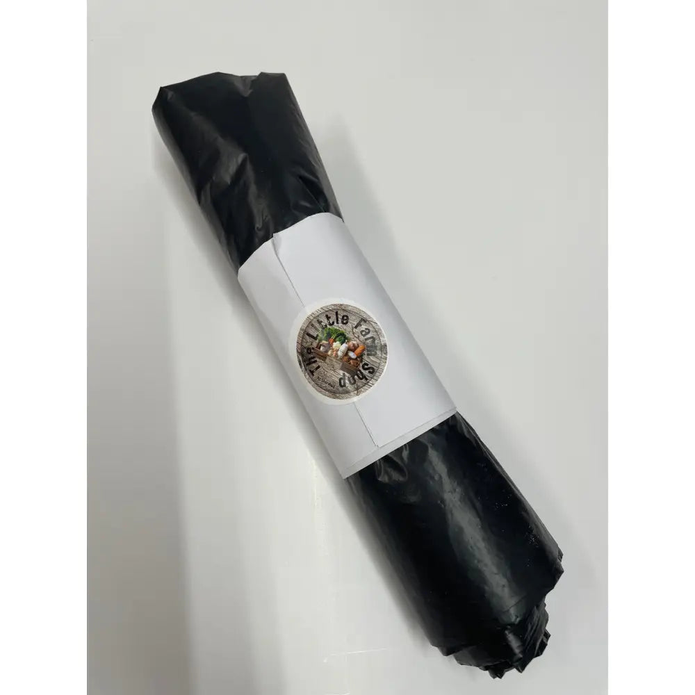 A black plastic wrapped pack of equestrian bin bags with a white paper band and little dudes sticker