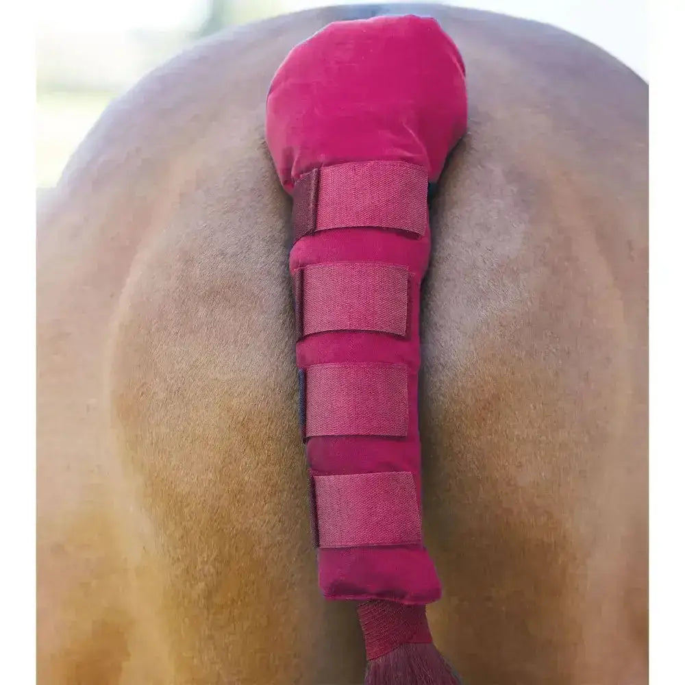 A plush fuchsia bitz tail guard padded with velcro tabs featuring multiple adjustable velcro straps for secure fit