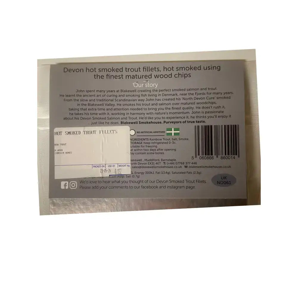 The back of a white and silver foil package of blakewell smokehouse devon hot smoked rainbow trout fillets with ingredient details