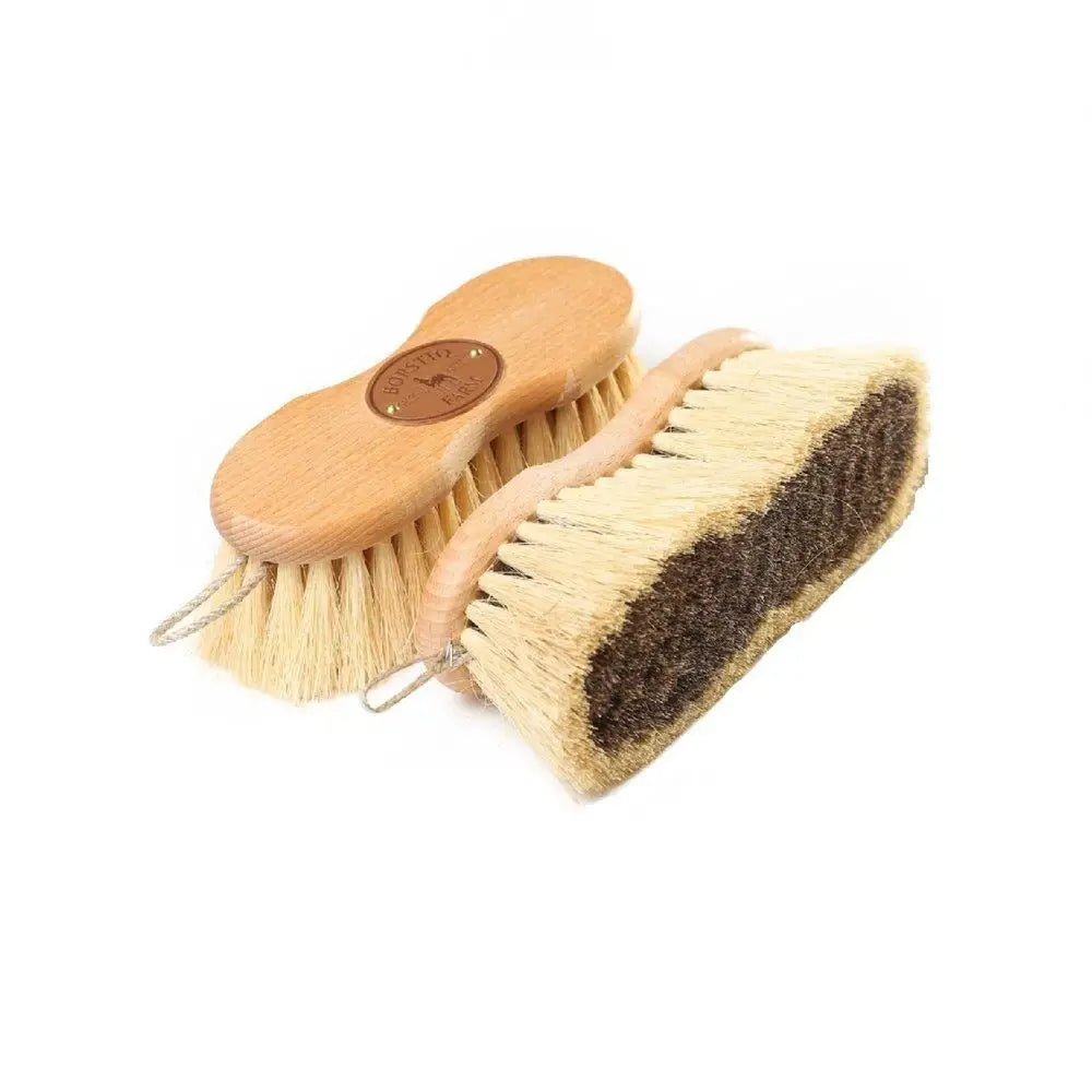 Two wooden handheld borstiq shaped mex soft brushes one with natural bristles one with dark brown scrubbing pad