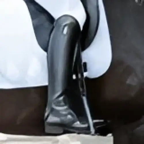 Black metal stirrup with textured surface and curved design on white saddle pad for brogini turin pro competition boots