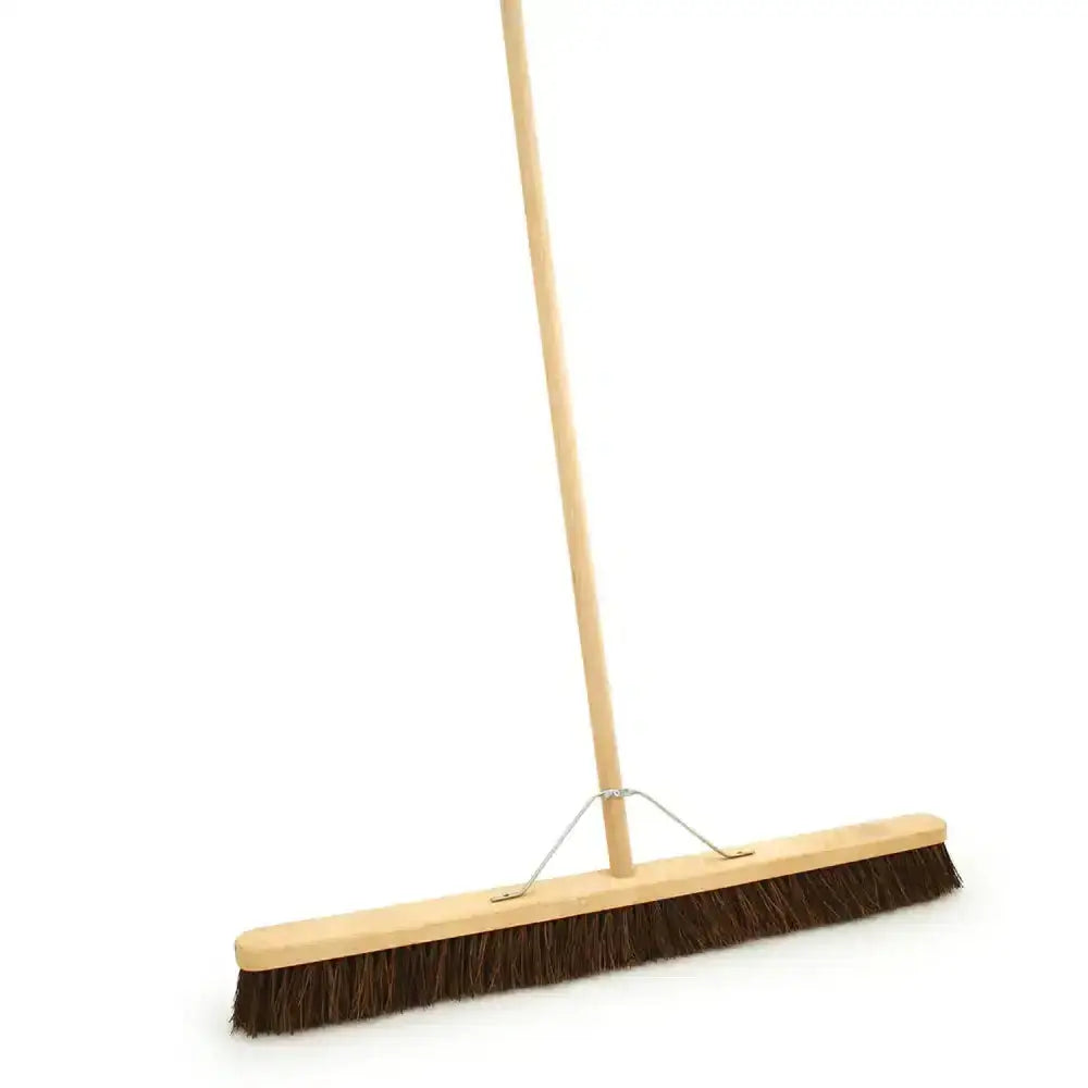 Brown bristle bassine broom head fitted with a light wood handle bassine broom for easy sweeping tasks