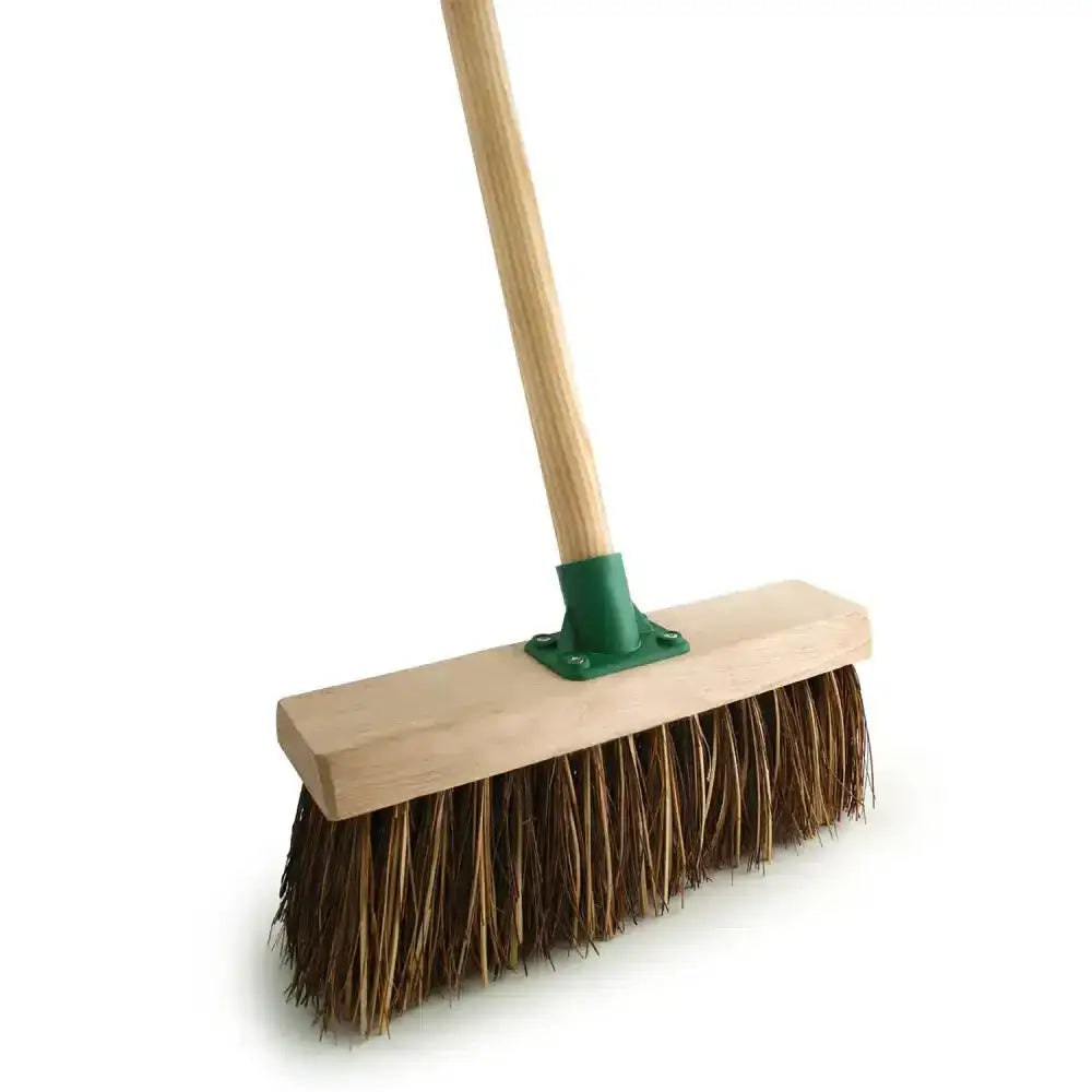 A bassine broom fitted with a sturdy wooden handle green metal ferrule and natural brown bristles with 4’6 handle