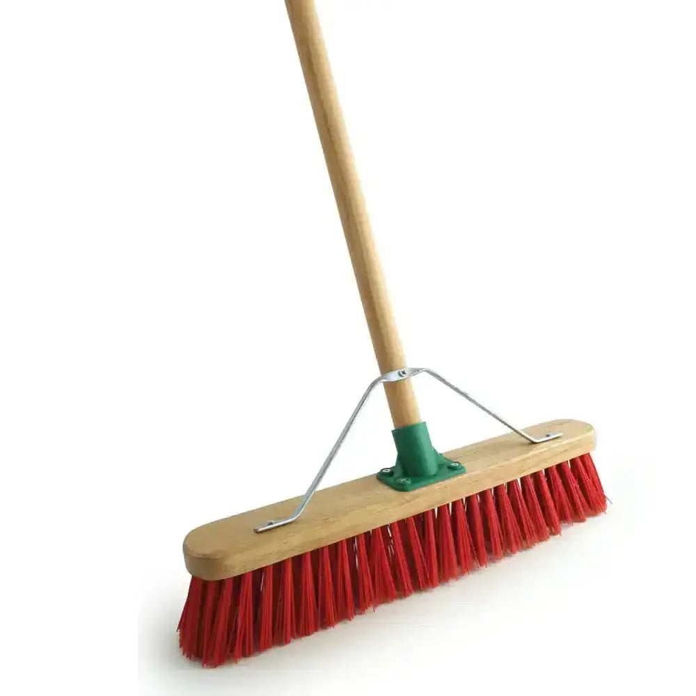 Red pvc broom with varnished red handle, light wood grip, and green metal ferrule for strong sweeping performance