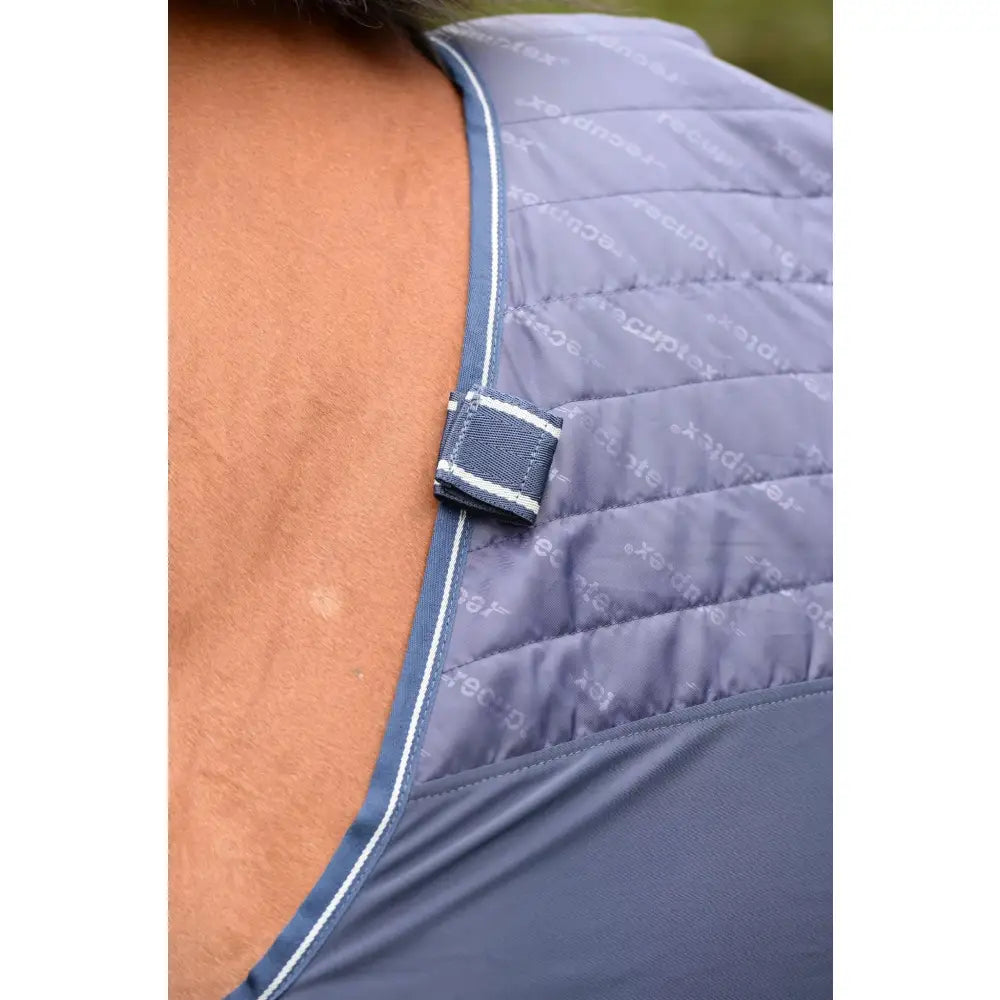 Blue quilted vest with white piping and fabric strap closure from bucas therapy mesh cooler collection
