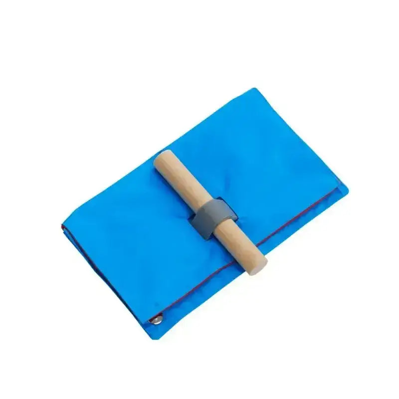 Bright blue fabric buster activity mat game envelope with a light wood handle and gray elastic band closure