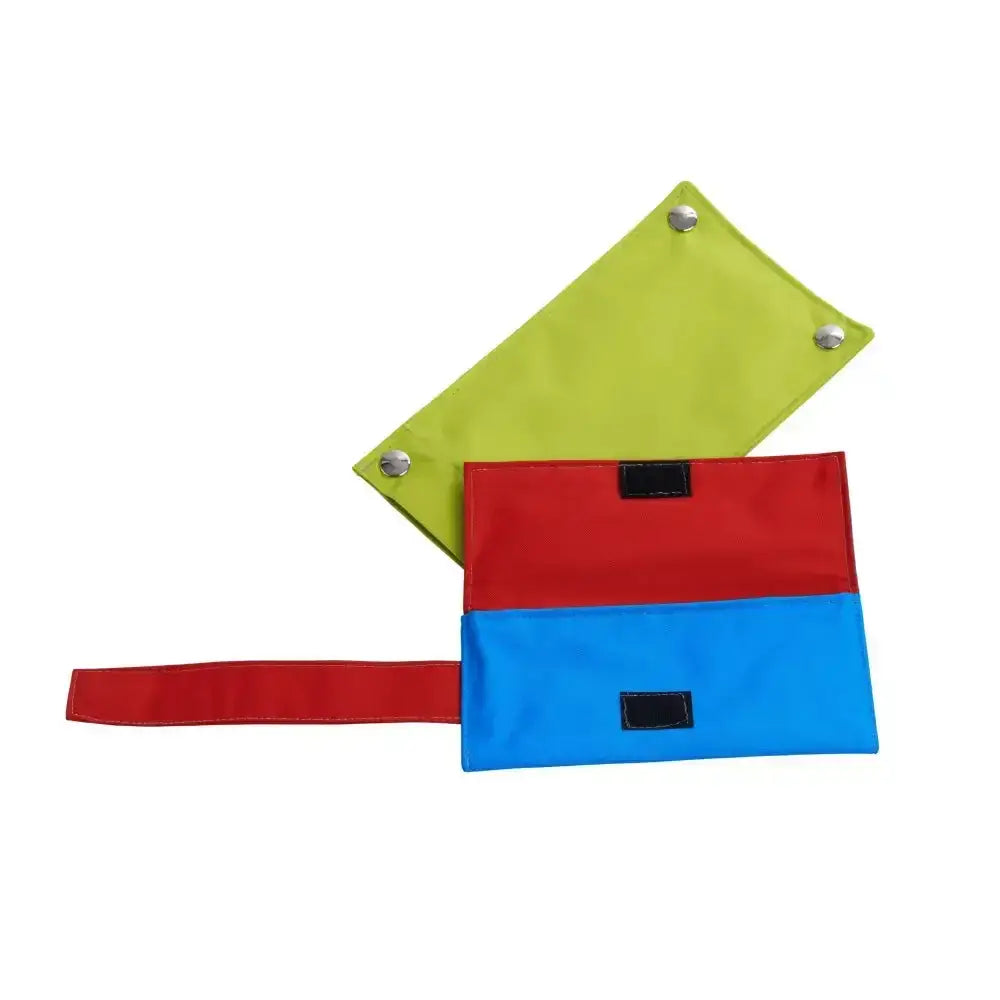Brightly colored lime green red and blue fabric pouches with silver grommets on buster activity mat game rat trap