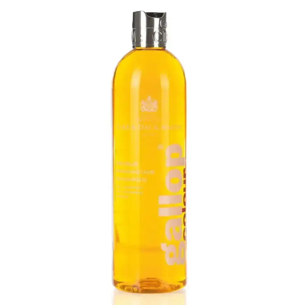 A transparent amber-colored bottle of carr day martin gallop colour shampoo with a silver cap and embossed branding