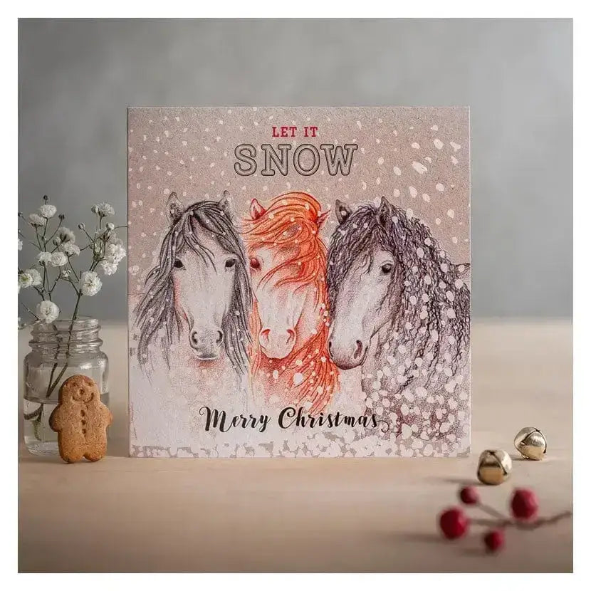 Christmas card let it snow with three horses and snowflakes on eco kraft fleck textured board beige background