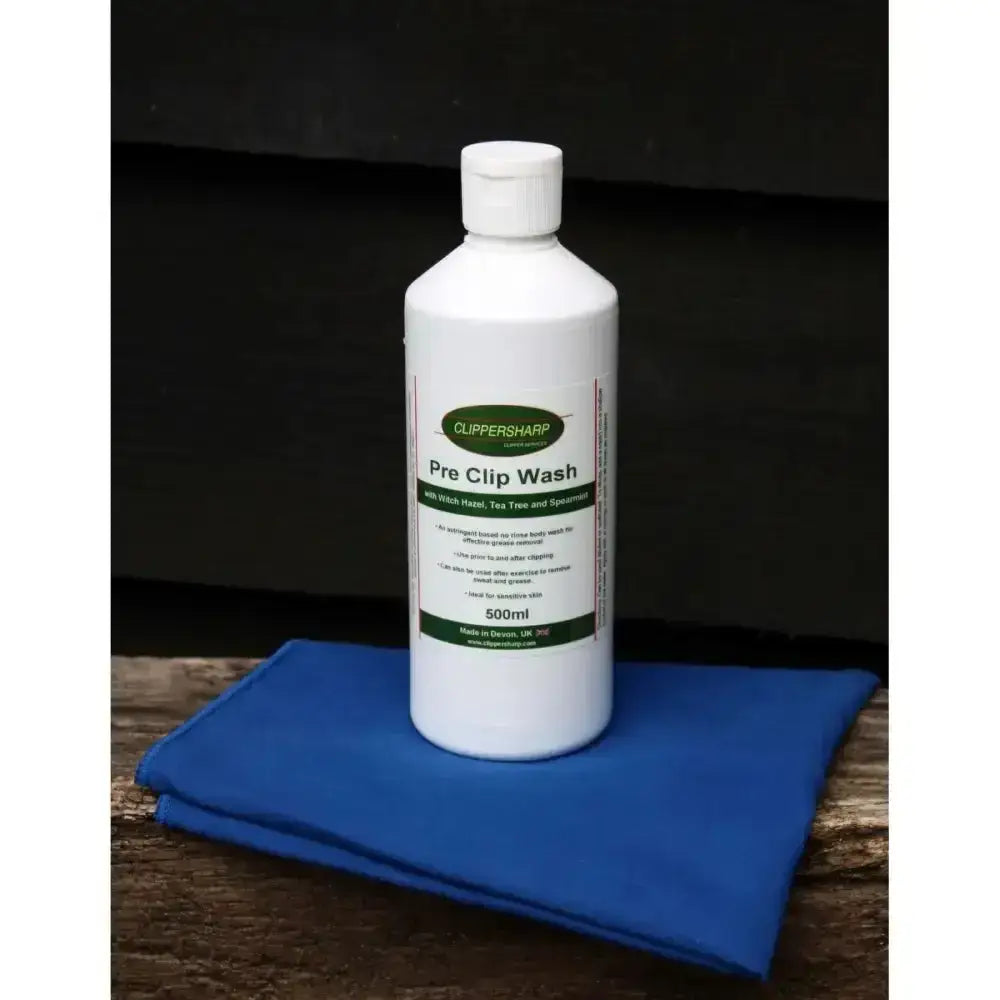 White plastic bottle of clippersharp pre clip wash with green label and white cap for effective grease removal 500ml