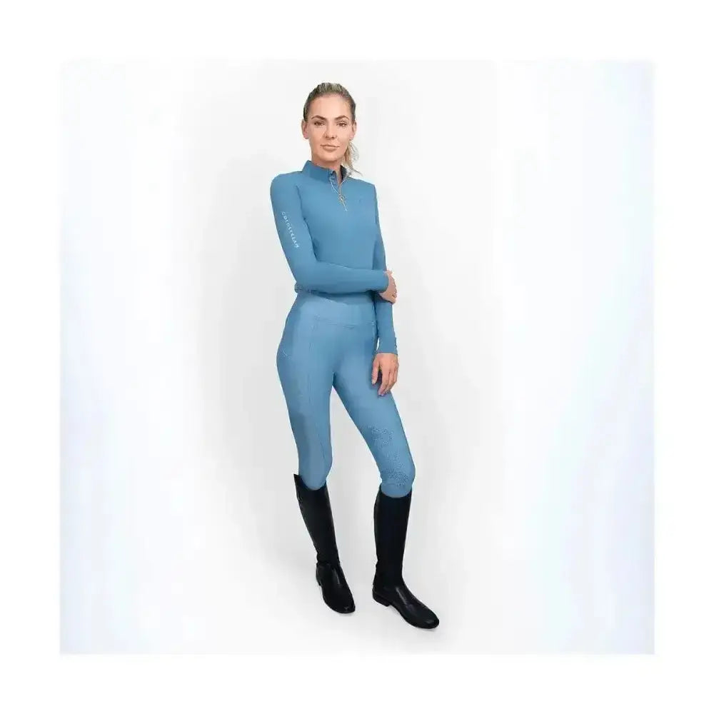 A sleek light blue coldstream ednam riding tights with high collar zipper front and technical capillary action fabric