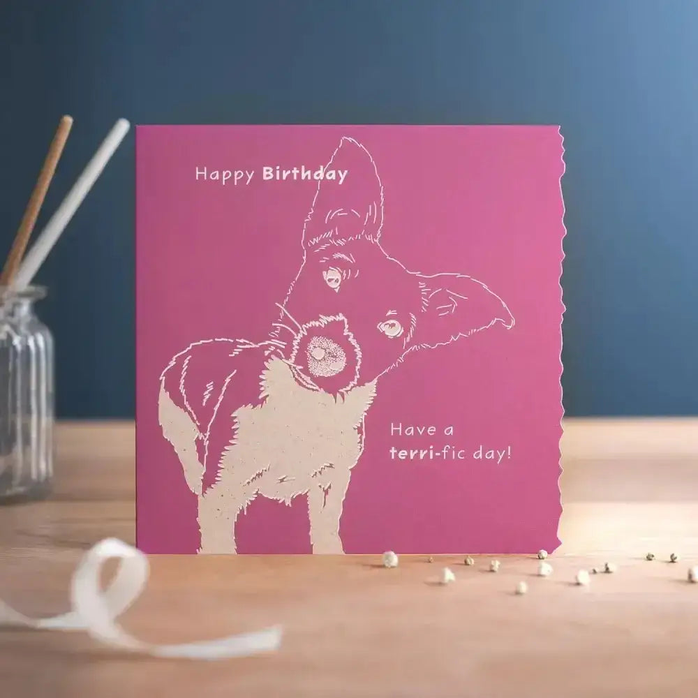 A vibrant pink colour block happy birthday terri card with a white terrier line art and terri fic day text