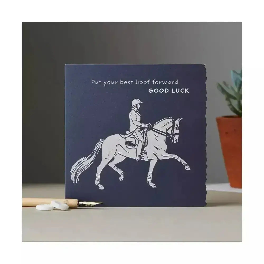 Navy blue colour block pony card with white line drawing of equestrian rider and good luck dressage message
