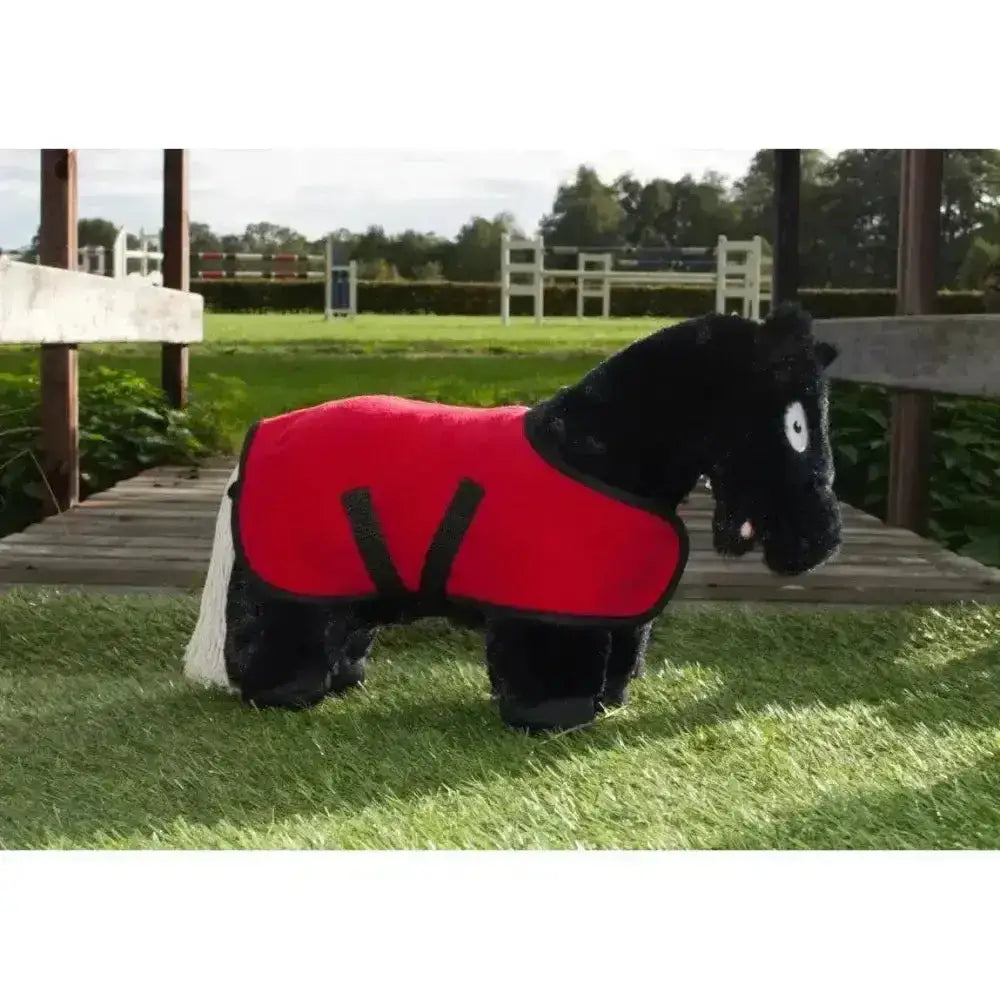 Black plush horse wearing a red riding coat with black straps from crafty ponies fleece pony fleece rug set