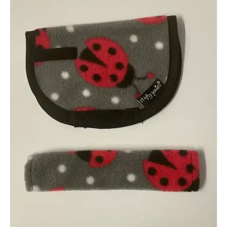 Gray fleece crafty ponies saddle cloth with red ladybug white polka dot pattern and black trim for girth sleeves