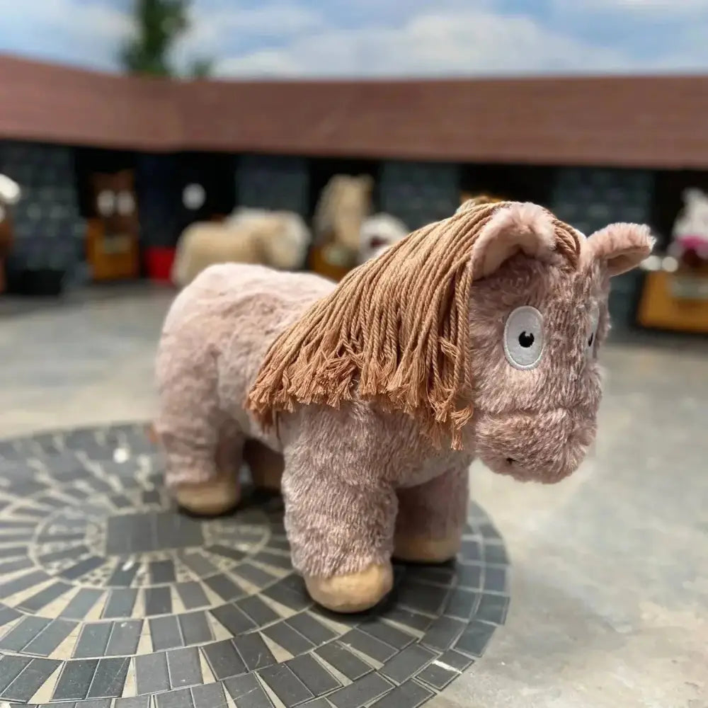 A soft pink crafty ponies soft toy pony roan with tan rope mane and big white eyes perfect for cuddling