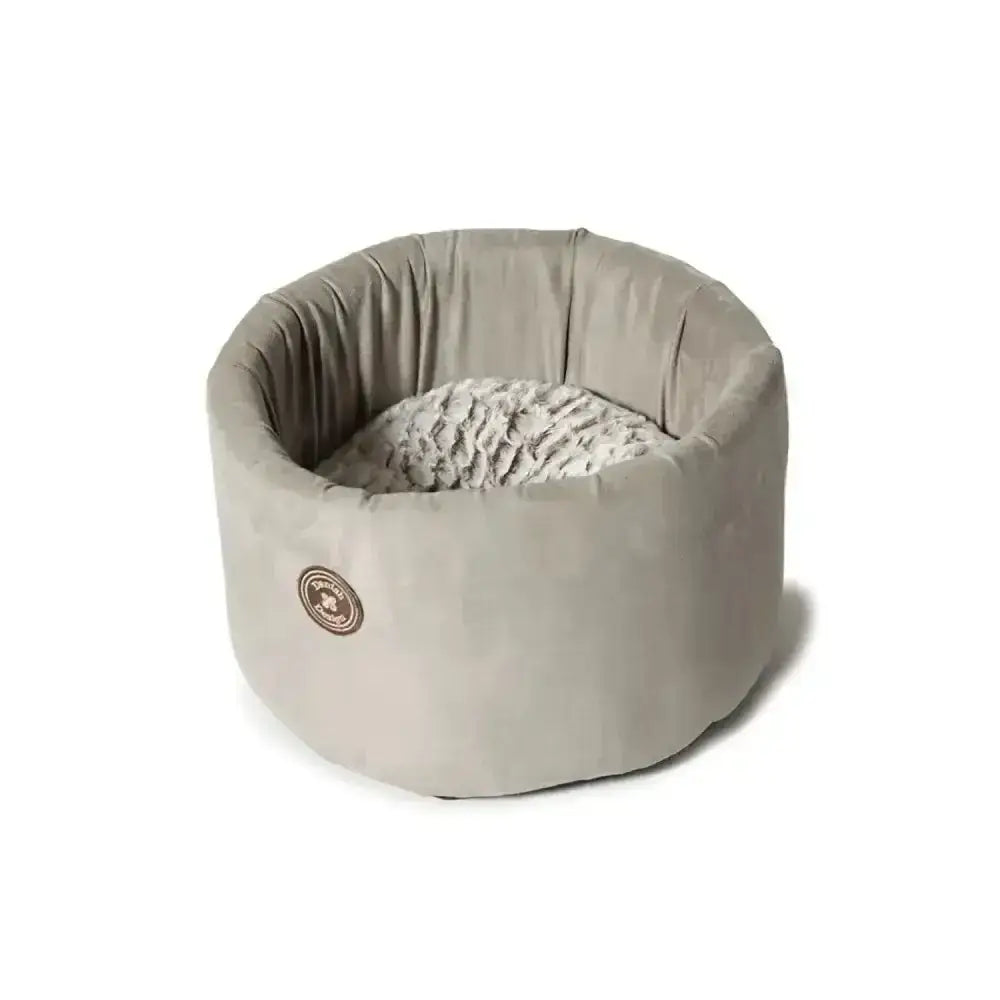 A cosy cat bed by danish design arctic with a soft gray plush exterior and textured white interior lining