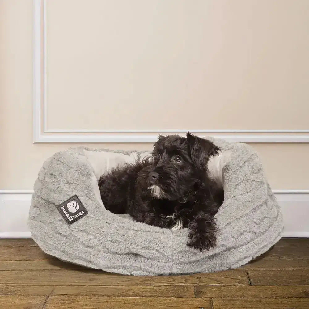 Gray plush dog bed with soft textured exterior and white lining from danish design bobble deluxe slumber bed collection