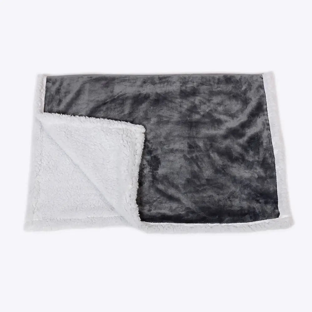 A plush gray and white sherpa fur blanket from danish design essentials with a soft textured surface perfect for cozy use