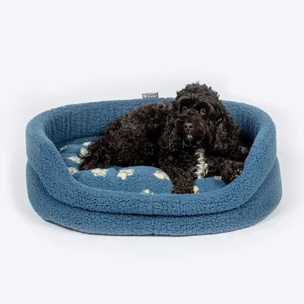 Blue fleece dog bed with white paw print pattern from danish design harbour paw fleece slumber bed collection