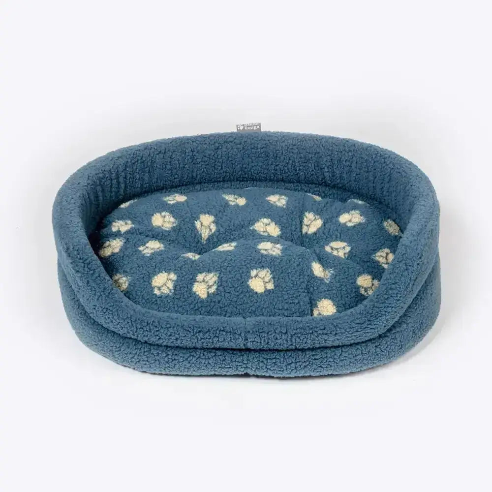 Blue plush dog bed with soft sherpa exterior and cushioned paw print interior from danish design harbour paw fleece slumber bed