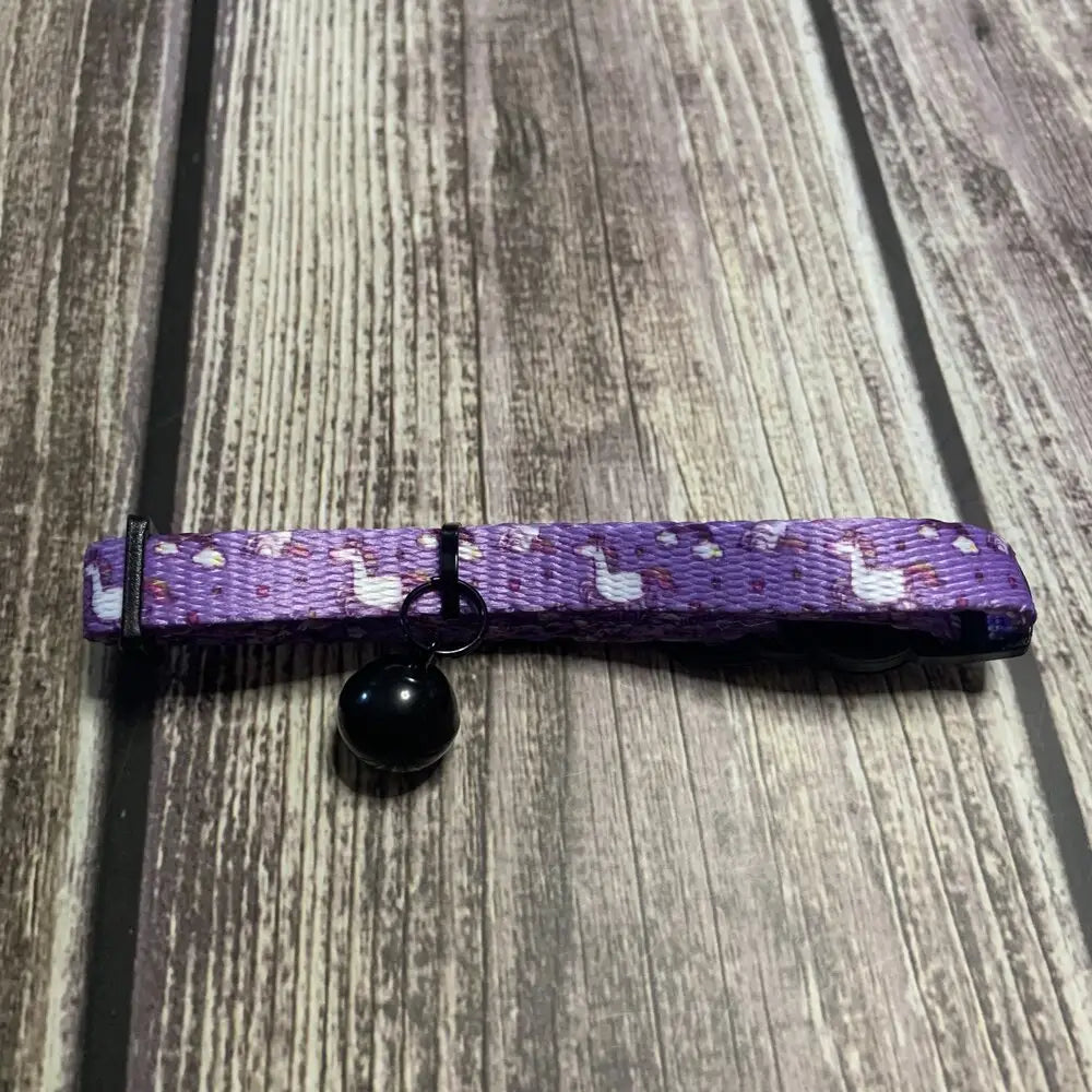 Purple woven quick release cat collar with white llama prints and black bell perfect unicorns cat collar