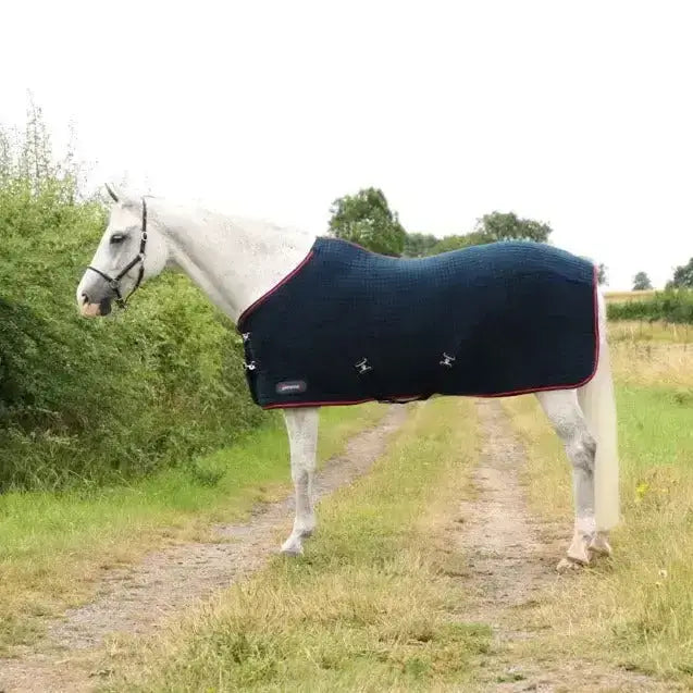 Dark blue defencex system cool control rug with red trim and silver buckle closures designed as a cool control rug